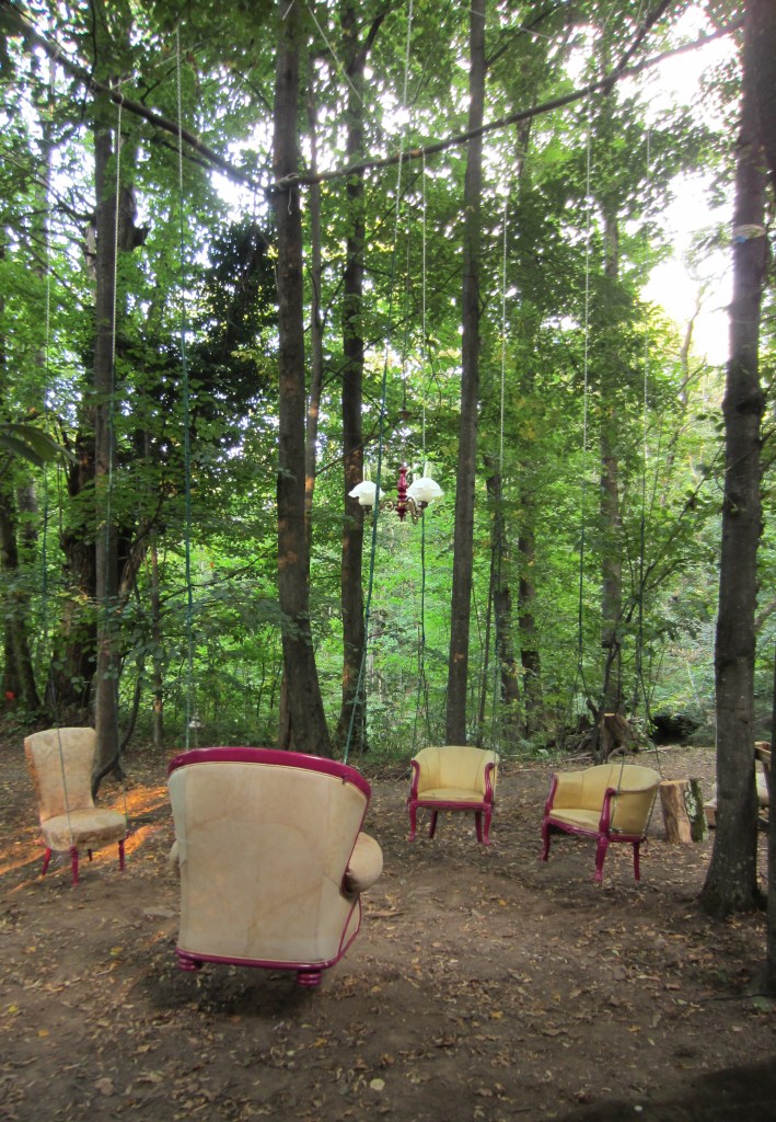 Children have always dreamed of a house in the woods. It's the stuff of fairytales and summer ramshackle treehouses. There's something about the complex, unknown, intriguing natural world which seems in direct contradiction with the idea of being HOME: safe, familiar, comfortable. As much as we romanticize about nature, and how soothing it is, we are always on our guard: careful not to poke ourselves on sticks or be stung by insects. Hence those things which make us feel at home taken out of context, seem even more reassuring. The sculpture plays on the tension between the natural and domestic world; between the familiar and the adventurous, between calm and playfulness.  But if we were really at home in nature, would we not treat it with more care...?